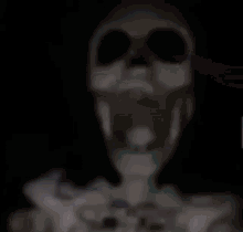 Skeleton hanging from a ceiling fan and spinning around